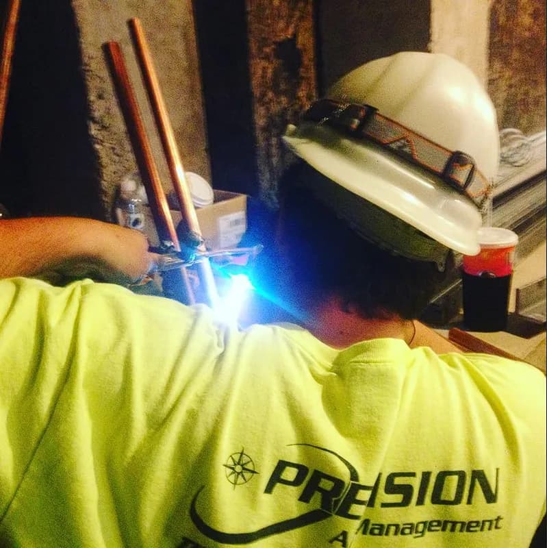 Technician brazing copper pipe