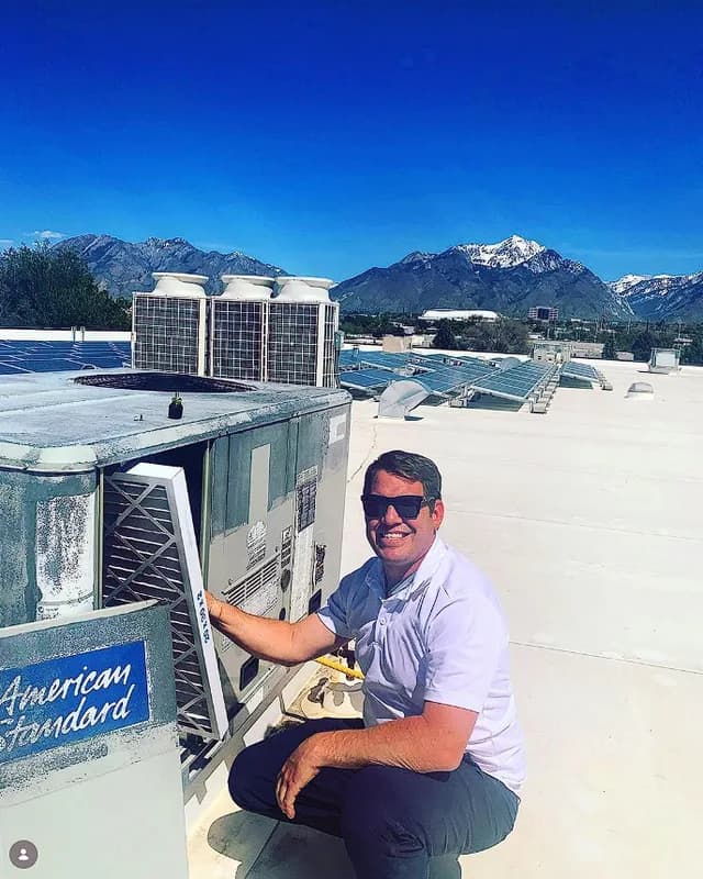 Technician servicing rooftop unit